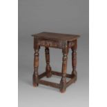 A Charles I oak joint stool, Gloucestershire, circa 1630 Having an ovolo-moulded top, leafy-filled