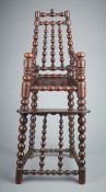 A rare and interesting Charles II turner's solid-walnut child's high chair, circa 1660 With four