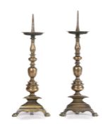 A pair of brass alloy, 'bell-metal', pricket candlesticks, Italian, circa 1590-1620 Each with a tall