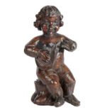 An Elizabeth I/James I walnut carved putti, circa 1590-1620 Carved in the round, designed seated