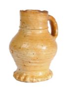A small 15th century stoneware jug, Raeren, German, circa 1450 Honey glaze, with characteristic