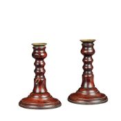 A pair of Queen Anne yew turned candlesticks, English, circa 1710 Each with a brass circular