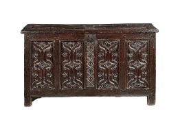 A fine and extremely rare Henry VIII oak parchemin-carved coffer, circa 1530 The hinged lid with