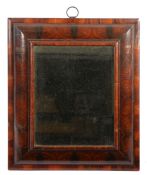 A William & Mary walnut oyster-veneered mirror, circa 1690  Having a cushion and moulded frame,