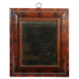 A William & Mary walnut oyster-veneered mirror, circa 1690  Having a cushion and moulded frame,