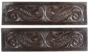 A pair of Elizabeth I carved walnut dragon panels, circa 1590-1600 The addorsed beasts with leafy