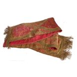 A long table runner of linen and silk crimson brocade, circa 1600 Applied with 'gold' lamellae