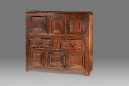 A rare Henry VIII oak joined and boarded livery cupboard, circa 1520-40 The top of two boards with