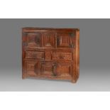 A rare Henry VIII oak joined and boarded livery cupboard, circa 1520-40 The top of two boards with