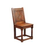 A rare Charles I joined oak closed-back side chair, Derbyshire, circa 1630, The back panel carved