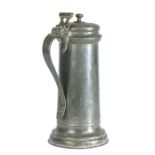 A large Charles I pewter flagon, circa 1630 Having a plain tapering drum with flared footrim, a