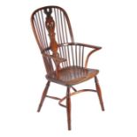 A yew high-back Windsor armchair, Buckingham, circa 1790-1830 The hooped back with scribed edge,