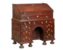 A rare William & Mary oak kneehole bureau, circa 1690 Of good bold design, having a one-piece slope,