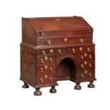 A rare William & Mary oak kneehole bureau, circa 1690 Of good bold design, having a one-piece slope,