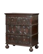 A unique Charles II joined oak tall chest of drawers, circa 1660 The boarded top with double-