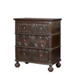 A unique Charles II joined oak tall chest of drawers, circa 1660 The boarded top with double-