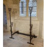 A pair of wrought iron cresset andirons, English, circa 1600 Of particularly tall form, with