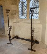 A pair of wrought iron cresset andirons, English, circa 1600 Of particularly tall form, with