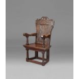 A documented and good James I oak panel-back open armchair, circa 1620 The rectangular back panel