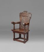 A documented and good James I oak panel-back open armchair, circa 1620 The rectangular back panel