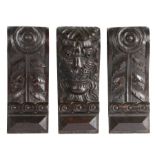 Three Elizabeth I carved oak corbels, circa 1590 One carved as a lion mask, snarling and with