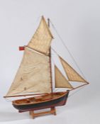 Model of a Smack fishing boat, with maroon and black painted hull, the hull 38cm long