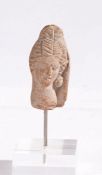 Terracotta Graeco-Roman head, modelled with flowing hair, 7cm high, on a modern stand