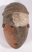 Salampasu tribal mask, Democratic Republic of Congo, with painted face, narrow eyes and mouth,