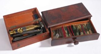 Late 19th Century brass and stee travel microscope, with attached tripod, housed in a mahogany case,