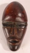 Dan Deangle tribal mask, Liberia, with narrow eyes and domed forehead, 29cm long