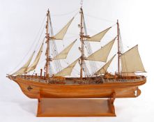 Wooden model of an unnamed sailing vessel, presented on a plinth base, 122cm high, 156cm long