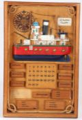 Novelty Spanish ship diorama calendar, centred with a boat with the months and days below, housed in