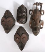 Four West African tribal masks, to include a pair, the largest 38cm long (4)