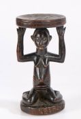 Luba headrest, Democratic Republic of Congo, the circular platform above a kneeling female figure,