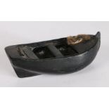 19th Century folk art toy boat, the dug out boat with nailed in sets and twine to the bow, 20.5cm