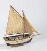 Model cutter boat, with two masts and brown and white painted hull, the hull 34cm long