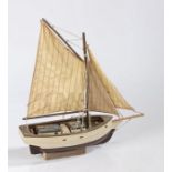 Model cutter boat, with two masts and brown and white painted hull, the hull 34cm long