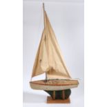 Single masted pond yacht "Girelle", possibly French, the two piece sail above a wooden deck, metal