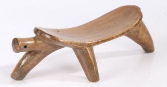 Arbore headrest/stool, Southern Ethiopia, the arched platform with ridged underside, raised on three