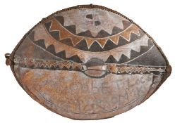 Maasai tribal hide shield, East Africa, painted in iron red, black and white, with faded writing,
