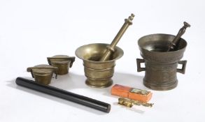 Two brass pestles and mortars, two cased sets of Nuremberg weights, ebony draughtsman's rule, set of