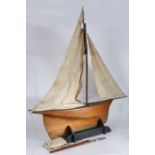 A good pond yacht, the single mast with three sails,  the wooden hull with metal base to the keel,