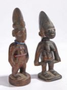 Two Yoruba fertility figures, to include male and female examples, the male figure with bead