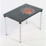 Tile topped table. The top inset with six floral tiles depicting an orange flower, raised on