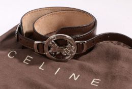 A Celine brown leather adjustable belt, silvered circular buckle with horse and carriage motif,