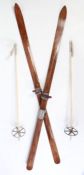 A pair of wooden vintage, c.1930-40's skis and ski poles in excellent condition. The skis which
