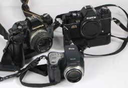 Konica FP-1 camera, together with an Olympus OM40 camera, a Kodak digital camera and a carrying