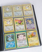 A collection of Pokémon cards housed in a Pokémon TCG folder. To include vintage cards, newer