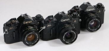 Three Canon A1 cameras with two 50mm lenes and a 28mm len (3)