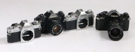 Four Canon SLR Cameras including two  AV-1 and Two Canon A1, with a 35-70mm 1:4 canon lens and a